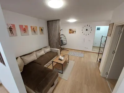 a living room with a couch and a table at Apartman Muzika Jagodina in Jagodina