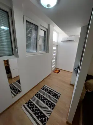 a small room with a staircase and a window at Apartman Muzika Jagodina in Jagodina