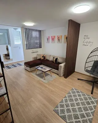 a living room with a couch and a table at Apartman Muzika Jagodina in Jagodina