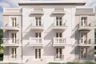 a white building with balconies on the side of it at Apartman Ina in Vrnjačka Banja