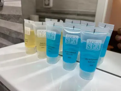 a group of four bottles of lotion on a counter at Bora Apartmani - FREE PARKING - CITY CENTER in Vranje