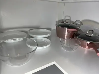 a counter top with bowls and other kitchen utensils at Bora Apartmani - FREE PARKING - CITY CENTER in Vranje