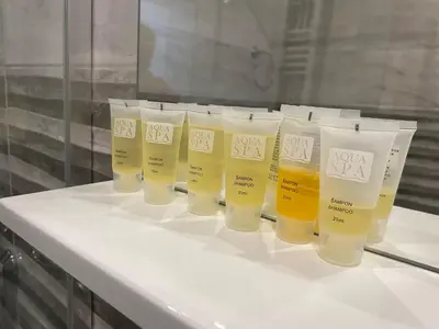 a group of four bottles of sunscreen sitting on a counter at Bora Apartmani - FREE PARKING - CITY CENTER in Vranje