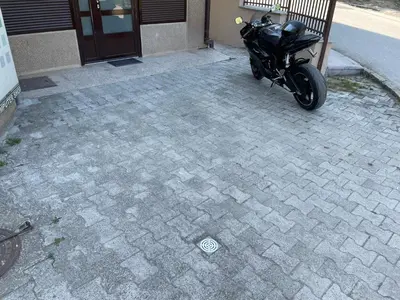 a motorcycle parked in front of a building at Bora Apartmani - FREE PARKING - CITY CENTER in Vranje