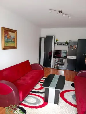 a living room with a red couch and a table at Apartman Dragana in Pirot