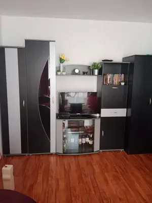 a living room with a black and white kitchen at Apartman Dragana in Pirot