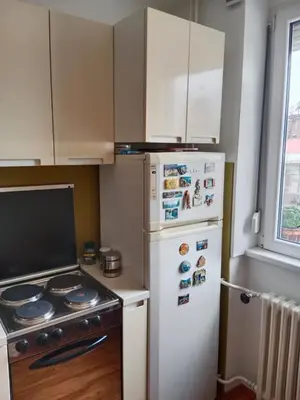 a kitchen with a stove and a white refrigerator at Apartman Dragana in Pirot