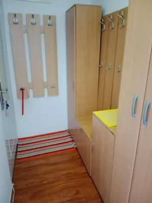a bathroom with wooden cabinets and a yellow counter at Apartman Dragana in Pirot