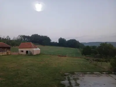 an old barn in a field of grass at Green apartments 2 in Kuršumlija