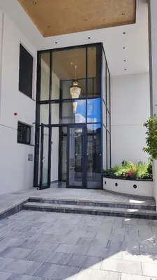 an entrance to a building with a large glass door at Lux Apartman Crnjanski II, Jagodina in Jagodina