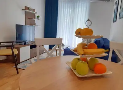 a table with two plates of fruit on top of it at Apartman SANA & Free GARAŽA in Vrnjačka Banja