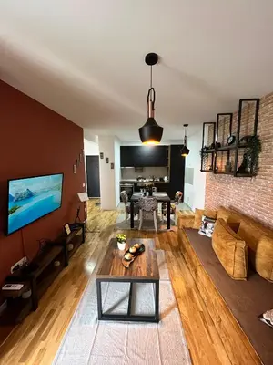a living room with a couch and a table at Lux apartment 13 center, free parking in Niš