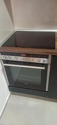 a stove top oven with a wooden counter top at Lux apartment 13 center, free parking in Niš