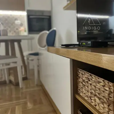 a kitchen with a table and a counter top at Apartman Indigo in Vrnjačka Banja