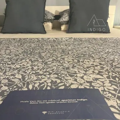 a black and white bed with a poster on it at Apartman Indigo in Vrnjačka Banja