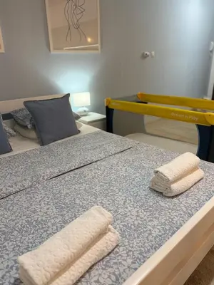 two towels on a bed in a room at Apartman Indigo in Vrnjačka Banja