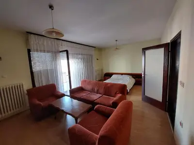 a living room with a couch and a table at City Park Rooms in Vranje