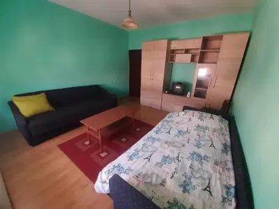 a living room with a bed and a couch at City Park Rooms in Vranje