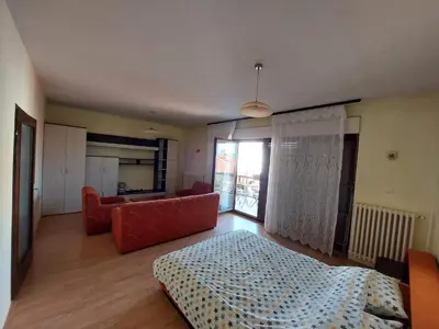 a living room with a bed and a couch at City Park Rooms in Vranje