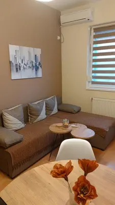 a living room with a couch and a table at Apartman Ninolić in Jagodina
