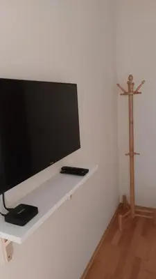 a flat screen tv sitting on a white wall at Apartman Ninolić in Jagodina