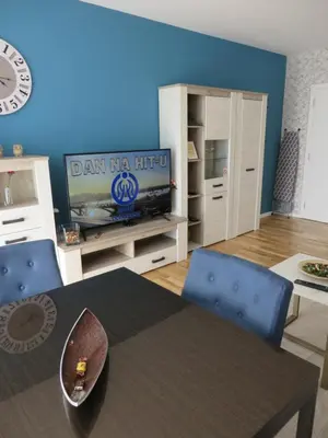a living room with a dining table and a tv at Lux apartment 10 center, free parking in Niš