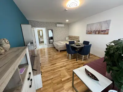a living room with a couch and a table at Lux apartment 10 center, free parking in Niš