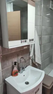 a bathroom with a sink and a mirror and a shower at Stan na dan Nis in Niš