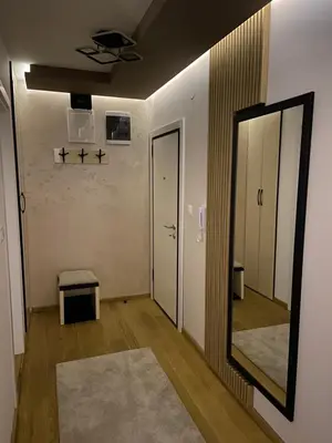 an empty room with a mirror and a hallway at Soul Apartment Vrnjačka Banja in Vrnjačka Banja