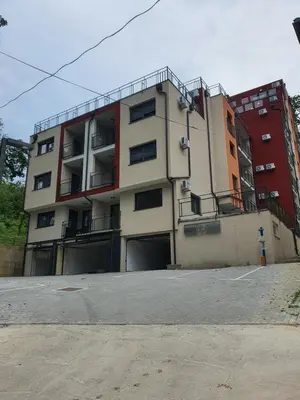 an apartment building with a parking lot in front of it at Soul Apartment Vrnjačka Banja in Vrnjačka Banja