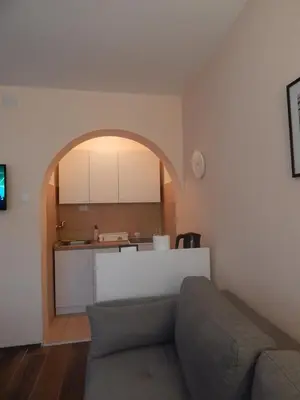 a living room with a couch and a kitchen at Apartman Luka in Vrnjačka Banja