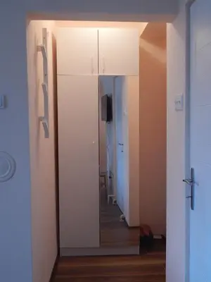 a room with a mirror and a hallway with a door at Apartman Luka in Vrnjačka Banja