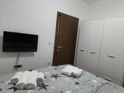 a bedroom with a table with rolled towels on it at Apartman ELENA in Jagodina