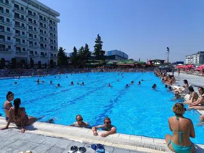 a large swimming pool with many people in it at Apartman ELENA in Jagodina
