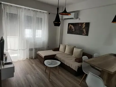 a living room with a couch and a table at Apartman ELENA in Jagodina