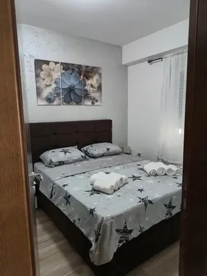 a bedroom with a bed with two towels on it at Apartman ELENA in Jagodina