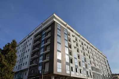 a tall building with a blue sky in the background at Apartman ELENA in Jagodina