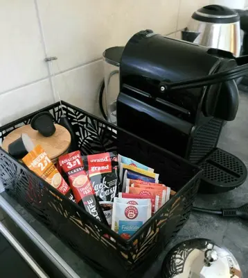 a basket filled with food and a coffee maker at Apartman Riva Parking Garaža in Kraljevo