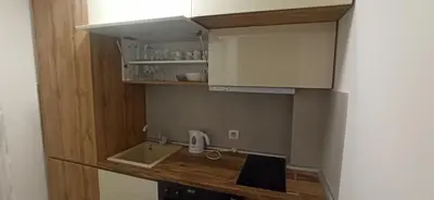 a small kitchen with a sink and a counter at Lux apartment 12 center, free parking in Niš