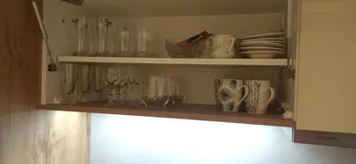 a cupboard filled with lots of glasses and dishes at Lux apartment 12 center, free parking in Niš