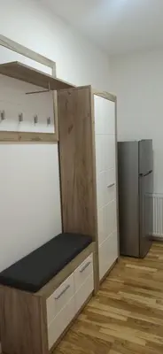 a small kitchen with a counter and a refrigerator at Lux apartment 12 center, free parking in Niš