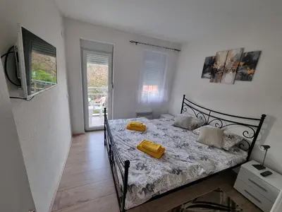 a bedroom with a bed with yellow pillows on it at Nada-S in Soko Banja