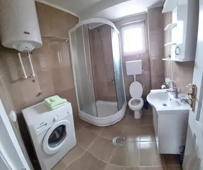 a bathroom with a washing machine and a sink at Nada-S in Soko Banja