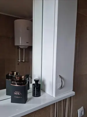 a white cabinet with two products on a shelf at Nada-S in Soko Banja