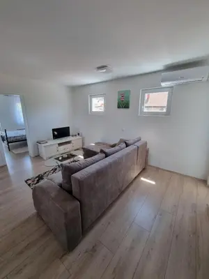 a living room with a couch and a television at Nada-S in Soko Banja