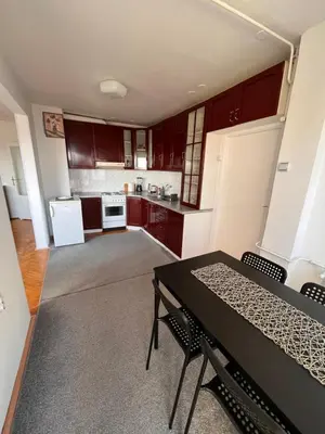 a kitchen with a table and chairs in a room at Devetka in Pirot