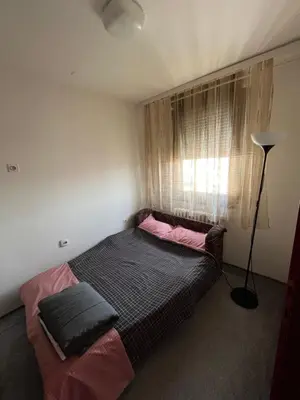a bedroom with two beds and a window at Devetka in Pirot