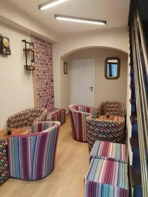 a waiting room with chairs and a staircase at UB Prenociste in Vranjska Banja