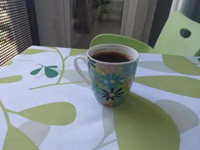 a cup of coffee sitting on a table at Green Apartman in Paraćin