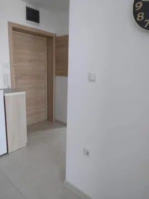 a room with a door to a kitchen with a tile floor at Green Apartman in Paraćin